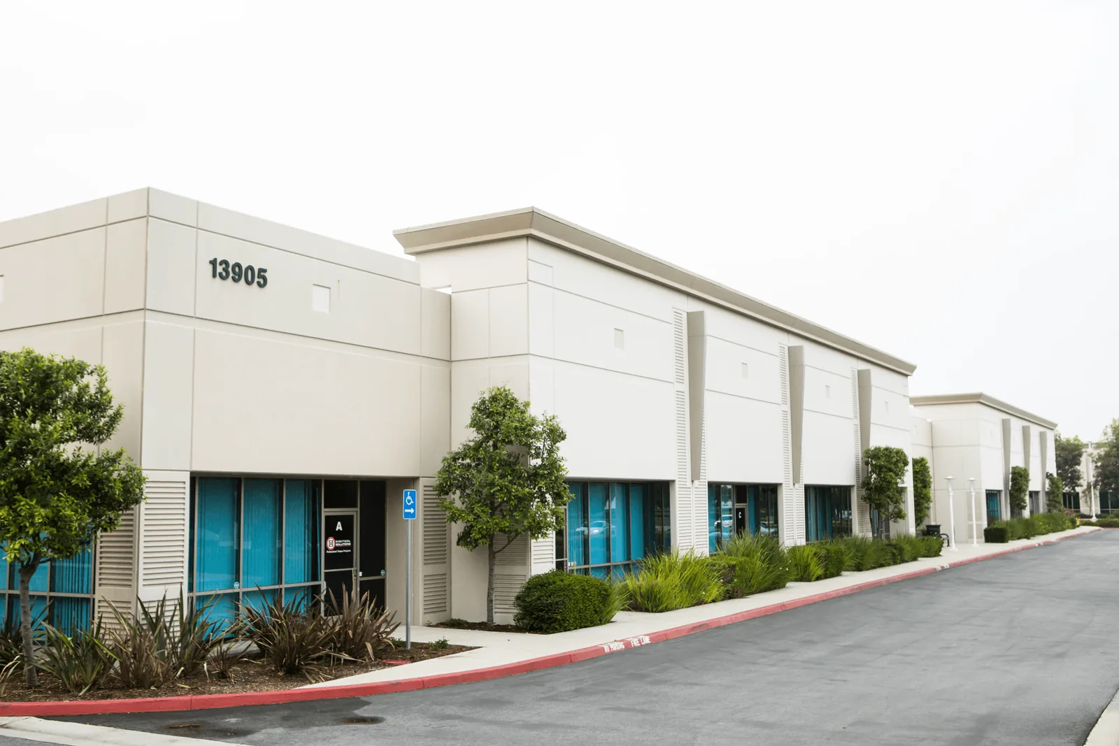 Commercial property exterior with parking and mountain views