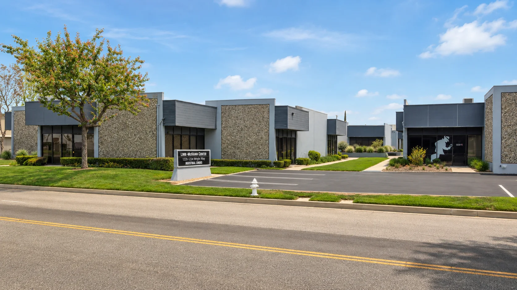 Link-McCann Center industrial property with landscaped parking and blue sky